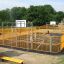 Outdoor multi-use sports court 'Basket' with yellow barriers and basketball hoops