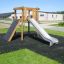 Wooden outdoor playground structure with a slide and climbing wall - Yosemite.