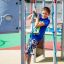 Child playing on Orca steel structure playground equipment.