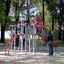 Children playing on a Butterfly steel structure in a park.