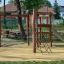 Children's playground equipment Alv with slide and climbing nets in a park.