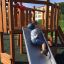 a boy sliding on a slide