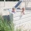 children playing in the white wooden playground ship