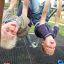 Children playing and hanging upside down on Alstad play structure.
