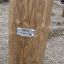 Wooden beam of Alstad playground product by Lars Laj with a metal label.
