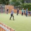 Children on the playground playing football against Goal 11570.