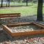 Bench, Steel Construction next to wooden sandbox in park