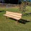 Bench, Steel Contruction on a grassy outdoor area near a small tree.