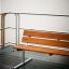 Bench, Steel Construction on wooden deck near water.