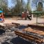 Steel Construction Table in a children's playground with benches and play structures in the backgrou