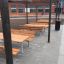 Outdoor Table & Bench set under pergola in schoolyard.