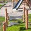 Wooden Kentucky playground bridge with chains in a park.