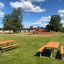 Outdoor seating area with Table & Bench in a park playground setting.