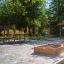 Table & Bench outdoor furniture set in a park with sandbox nearby.