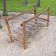 Dolomiti - wooden playground bridge structure in a park.