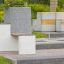 Modern urban bench Libra with concrete and wooden elements in a park setting.