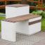 Concrete and wooden park bench Libra in a garden setting.