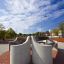 Outdoor concrete bench Dona with modern design in a public park.