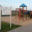 Playground structure Yukon with slides and climbing frames on sandy surface.