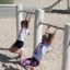 Children playing on Triple Somersault Nature playground equipment.