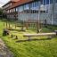 Wooden playground equipment comprising beams and ropes, named Sahara, installed on a green lawn in f