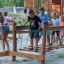 Wooden playground balance bridge Sahara with children playing outdoors