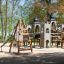 Wooden Tipi I climbing net on a playground.