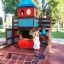 Children playing on a colorful playground structure with Rubber Tiles 90 flooring.