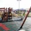 Rubber Tiles 110 on a playground with wooden structures and a slide.
