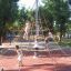 Children playing on a rope pyramid structure in a park with Rubber Tiles 110.