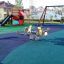 Playground with wetpour surface and outdoor play equipment.