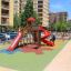 Playground with colorful Wetpour 100 surface and slides in urban area.