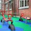 Playground equipped with Wetpour 100 rubber flooring and red seesaws.