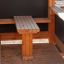 a wooden bench inside an outdoor playhouse