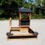 a playground house with a sandpit