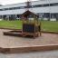 a black wooden playhouse with a sandpit