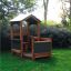 Outdoor wooden playhouse for children 'Veranda House Nature' in a garden setting.