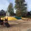 Playhouse Nature outdoor kids playhouse with slides and sandbox.