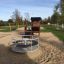 Playhouse Nature in a sunny playground with a sandbox and a carousel