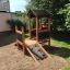 Children's wooden playhouse with climbing wall - Playhouse Nature.