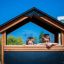 Children playing in the Country House Nature playhouse.