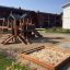 Wooden Tower Nature playhouse with slide in a playground.