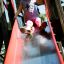 Child sliding down a red slide at the Sphinx castle with slide.