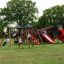 Children playing on the Mastodon castle with slide playground.