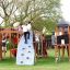 Children playing on Mastodon castle with slide on a playground.