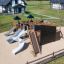 Playground Mastodon castle with slide in a green outdoor setting.