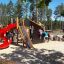 Mastodon castle with slide at a playground with children playing