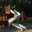 Playground Mastodon castle with slide in a forest setting.