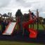 Mastodon castle with slide on a playground with children playing