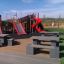 Playground featuring the Mastodon castle with slide set, including two red slides and climbing struc